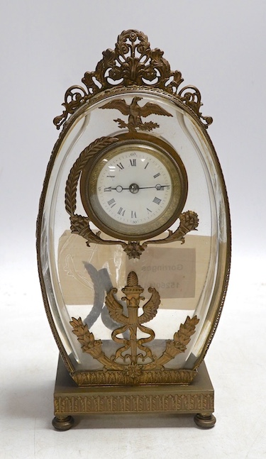 A French decorative oval shaped glass and gilt mounted mantel clock, 23cm high. Condition - good, unchecked if working